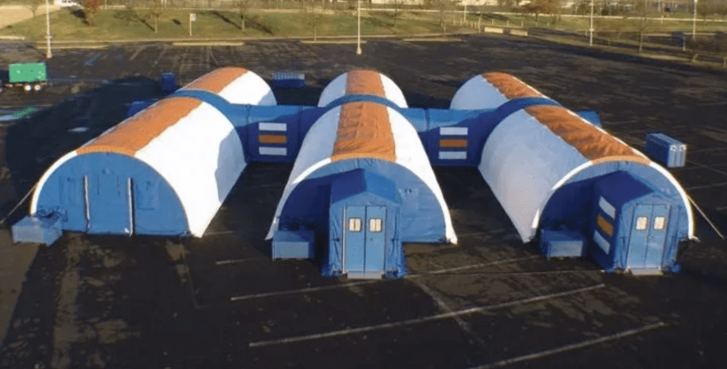 Colorful temporary field hospital shelters in a parking lot